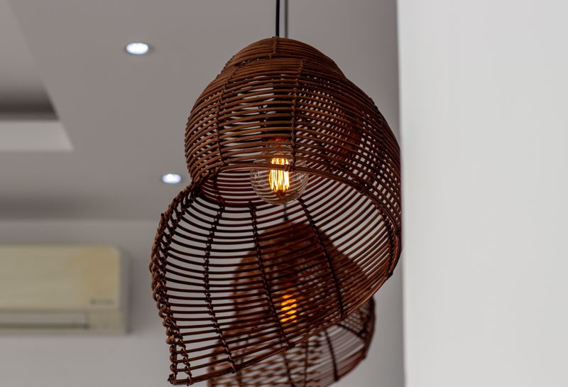 Handwoven rattan lighting in a softly furnished Miami interior