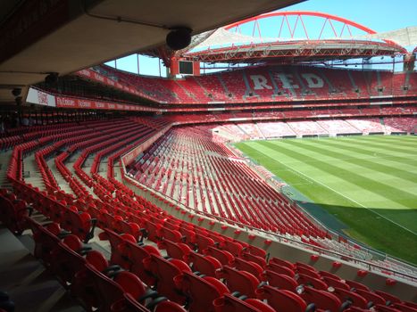 Wide-angle shot of the empty Estádio da Luz's bleachers and soccer field in Lisbon, Portugal.