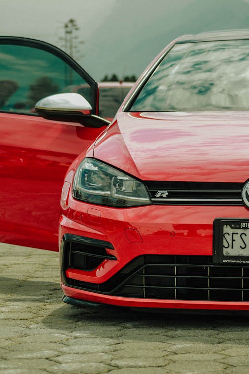 A Headlight of a Red Sedan