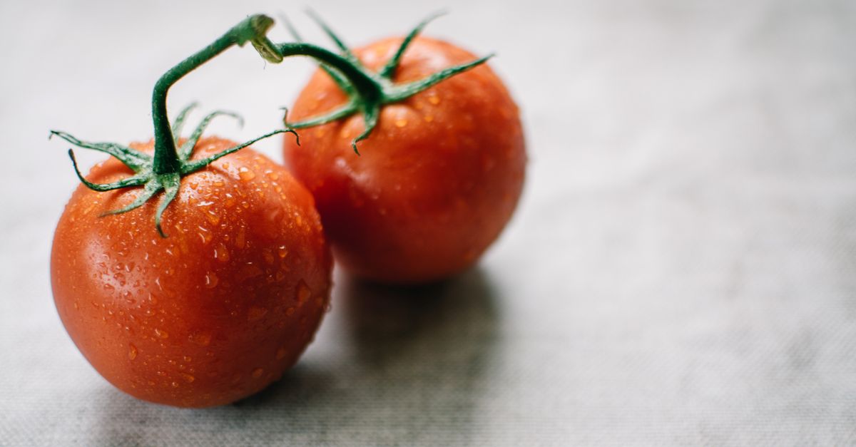 Close-up of fresh juicy tomatoes with water droplets on a textured surface, perfect for healthy living. - Evidence evidence guide for lycopene skin photoaging meta-analysis