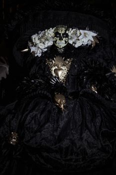 A striking Dia de Muertos costume featuring elaborate floral headdress and traditional makeup in Mexico City.