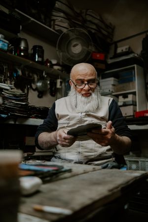 A bearded craftsman at his bench