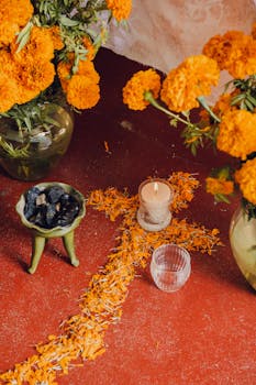 Vibrant Dia de Muertos altar with marigold petal cross and candle in Oaxaca, Mexico.