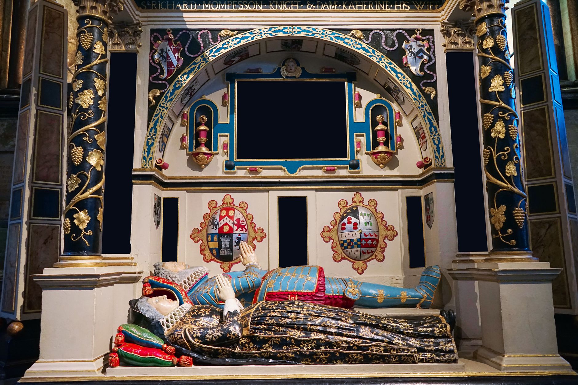 A detailed view of an ornate tomb featuring heraldry in Salisbury Cathedral, England.