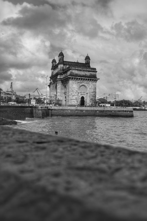 Free Stunning black and white photograph of the Gateway of India with the sea in the foreground. Stock Photo