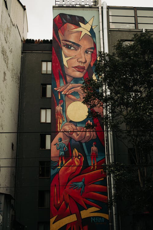 A Painting of a Woman on Wall of High Rise Building