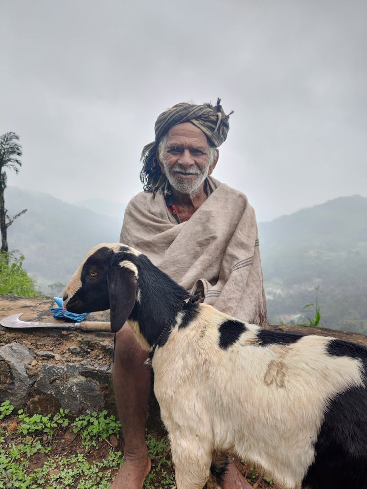 Elderly Man With Goat