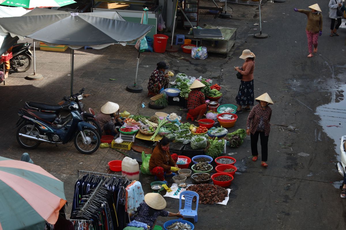 People at a busy street market in Vietnam. People at a busy street market in Vietnam.