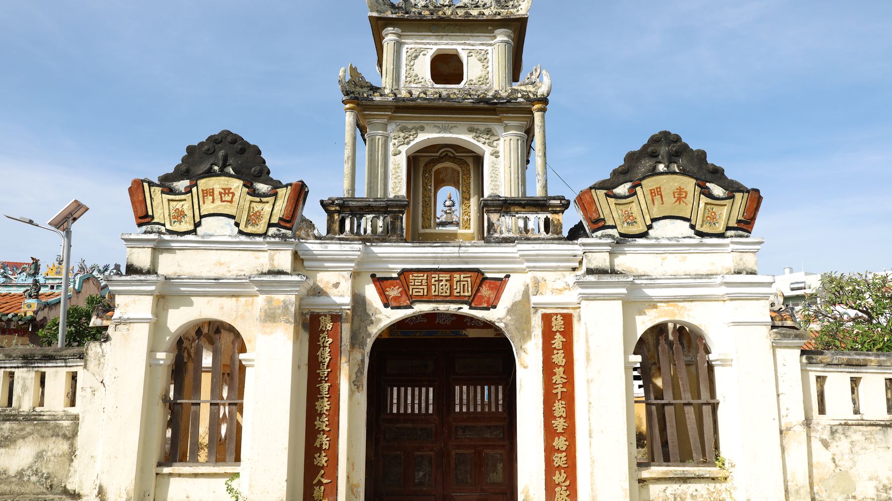 Beautiful old temple gate with ornate architecture under sunny skies.