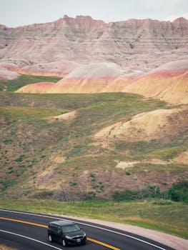 Explore the striking landscapes of Badlands National Park with winding roads and colorful rock formations.