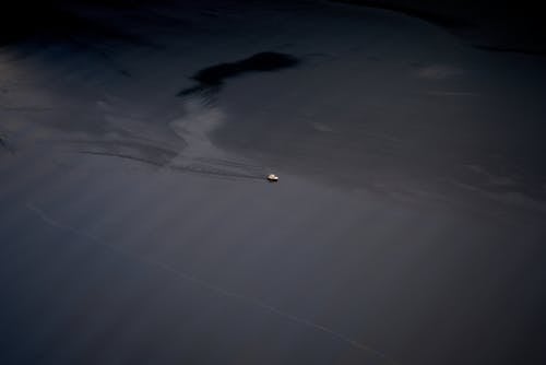 Aerial Photography of a Small Ship Sailing on the Sea