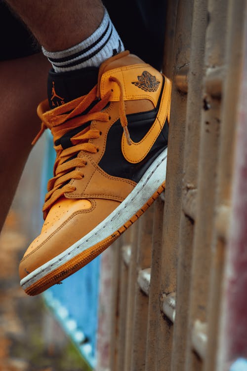 Close-Up Photograph of an Orange and Black Sneaker