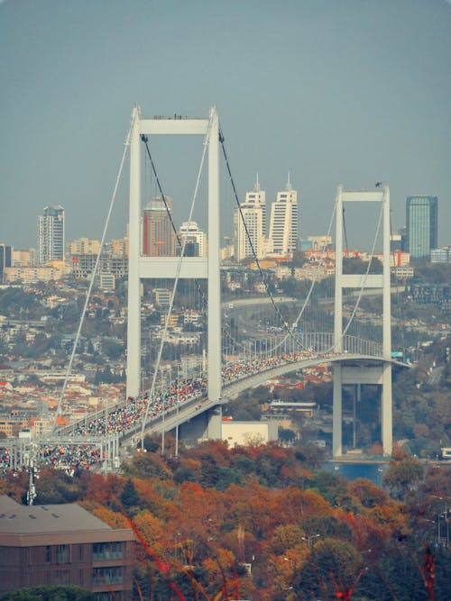 People on White Bridge Under Blue Sky