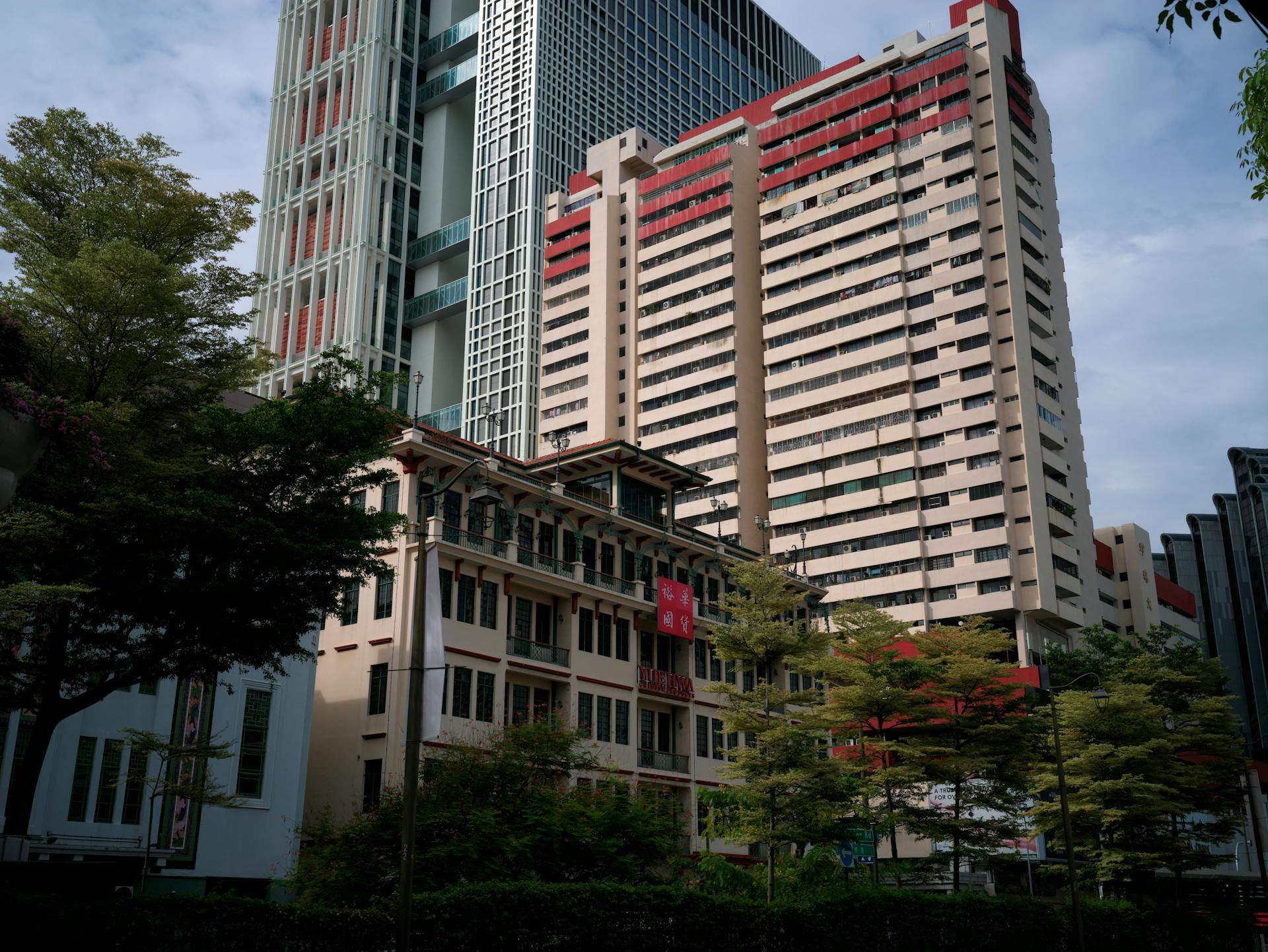 Low-angle view of skyscrapers and residential buildings in Singapore cityscape.