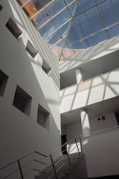 Low angle shot of a modern interior with a glass roof and minimalist design in Badajoz, Spain.