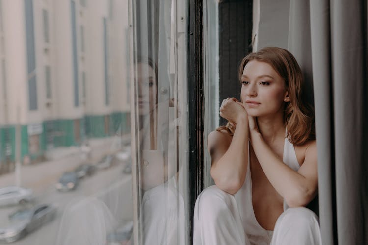 A Woman Looking Outside The Window