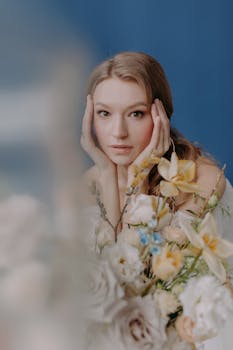 Elegant bridal portrait featuring a woman with a floral bouquet, posing indoors.