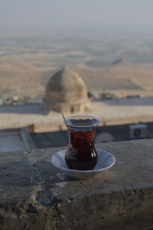 Free A glass of Turkish tea sits on a ledge, overlooking a beautiful landscape. Stock Photo