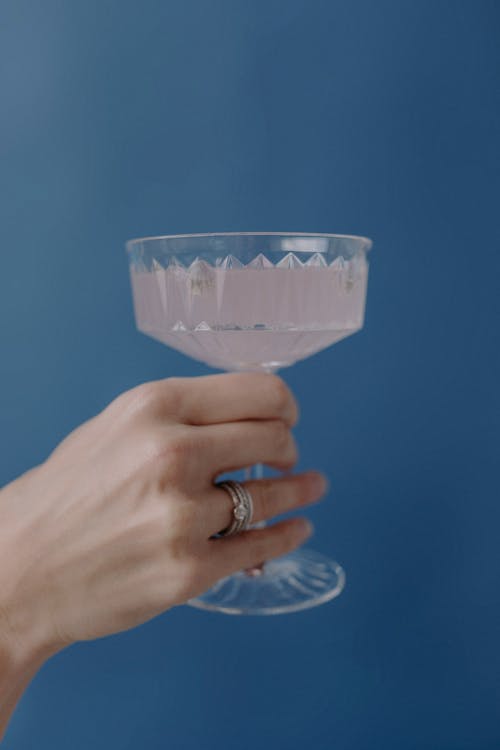 Close-Up Shot of a Person Holding Coupe Glass