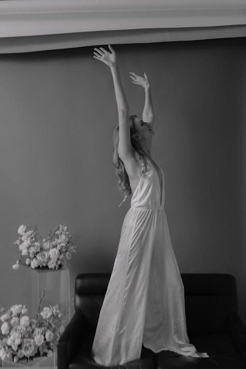 Model in a V-collar Dress Standing on a Sofa