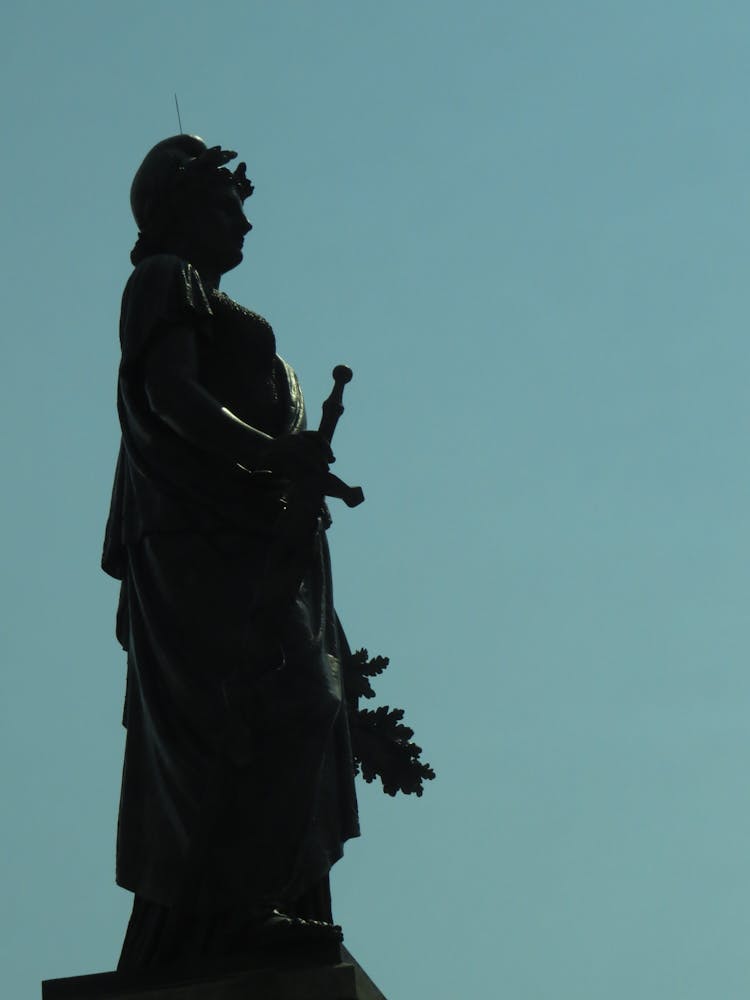 Silhouette Of Statue On Blue Sky