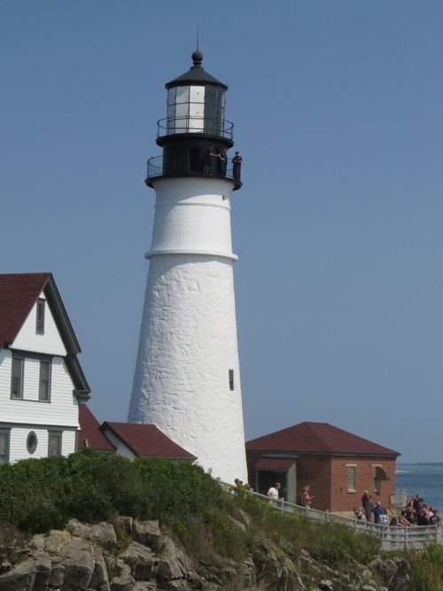 Free Historic Portland Head Light with blue sky and tourists in Maine. Stock Photo