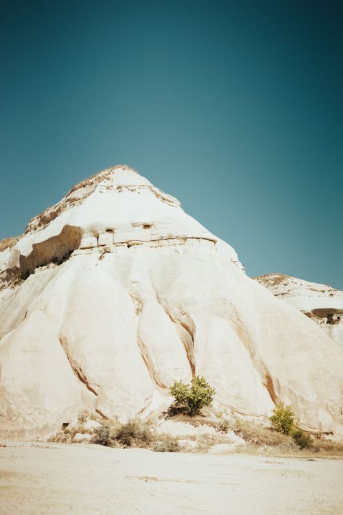 Free Breathtaking view of Cappadocia's unique rock formations against a clear blue sky in Turkey. Stock Photo