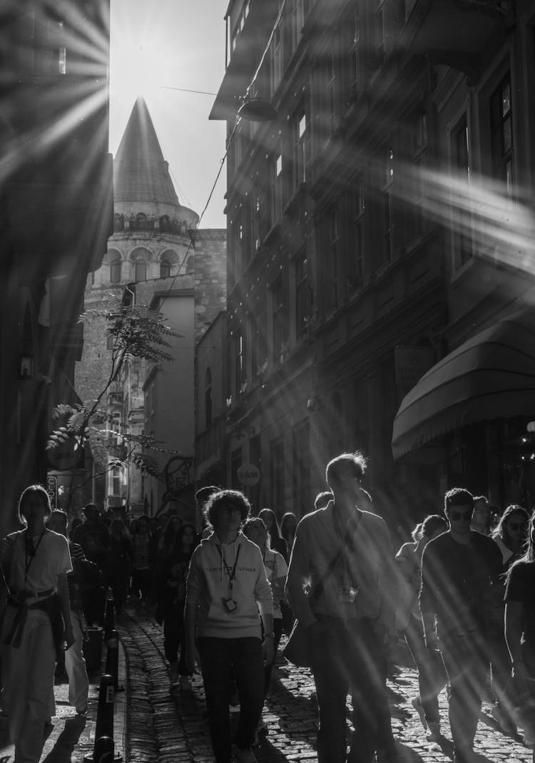 Grayscale Photograph Of People Walking On A Street