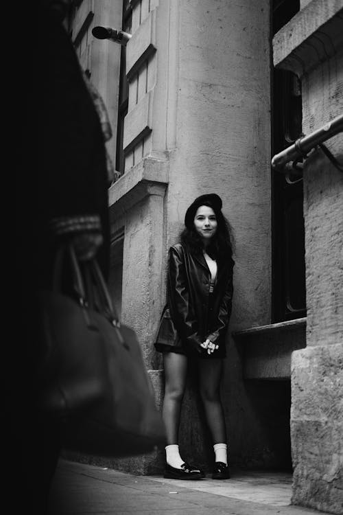 Grayscale Photograph of a Woman in a Leather Jacket