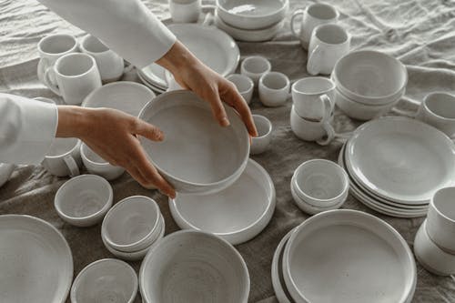 A Person Holding White Ceramic Bowl