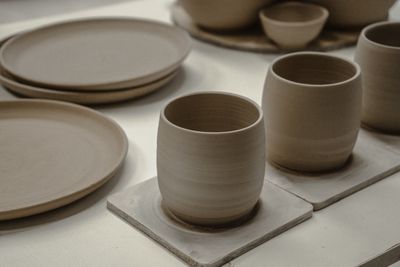 Ribbed stoneware mugs on stone tiles, photo by Галина Ласаева on Pexels