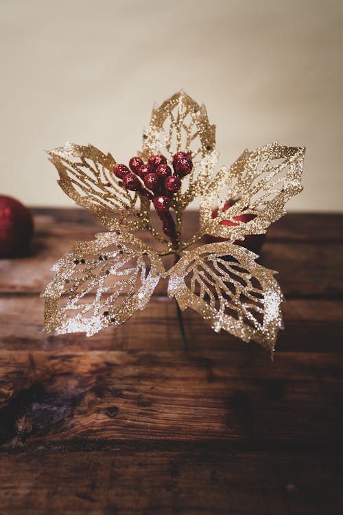 Red and Gold Baubles on Brown Wooden Table