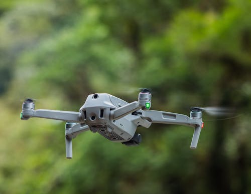 Close-Up Shot of a Gray Drone in Mid Air