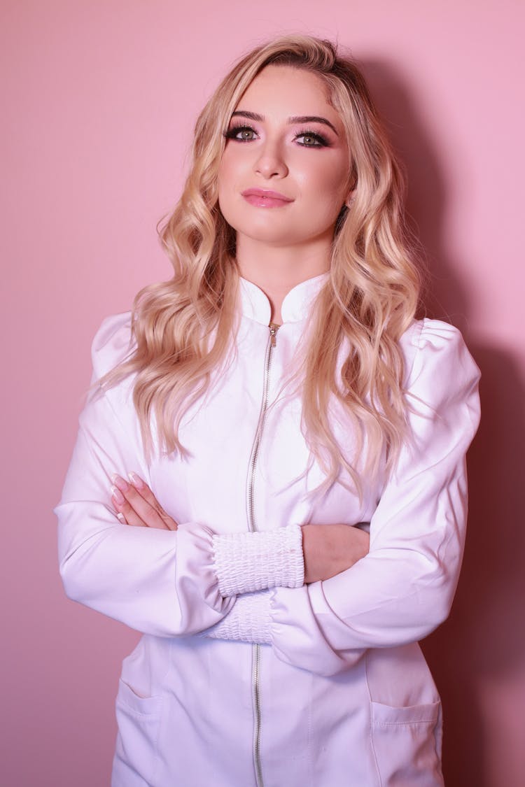 Woman In White Jumpsuit Standing While In Crossed Arms