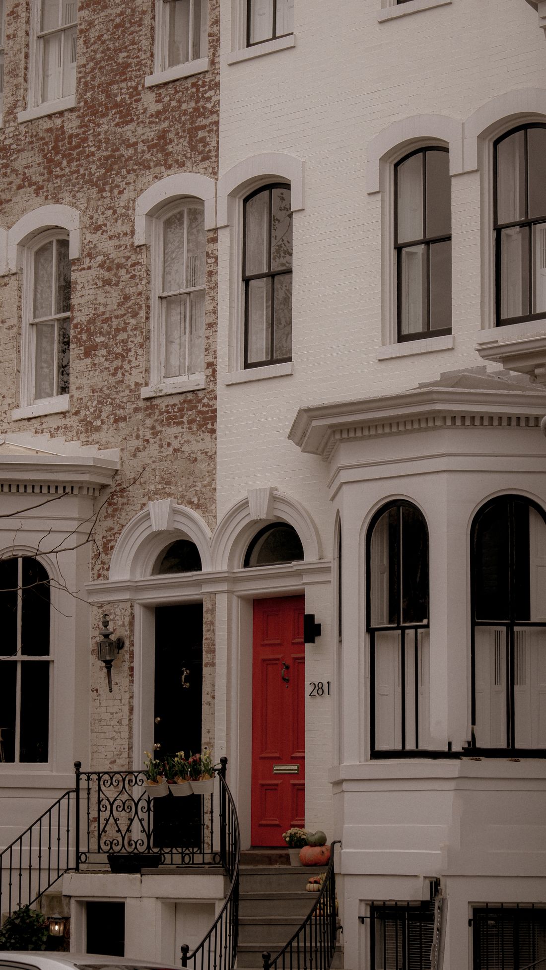 Classic brick townhouses with a striking red front door