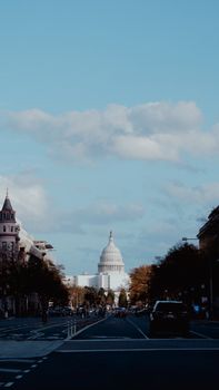 Street view of the US Capitol Building in Washington DC with light traffic.