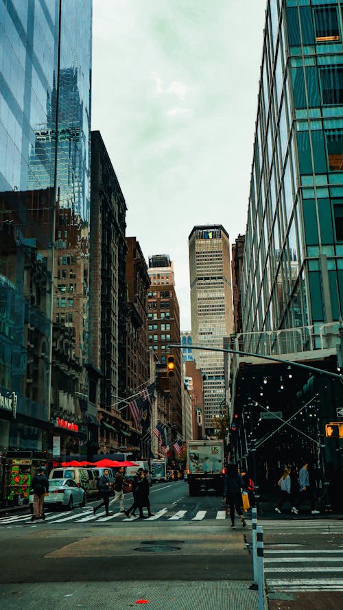 Cars on Road Between High Rise Buildings