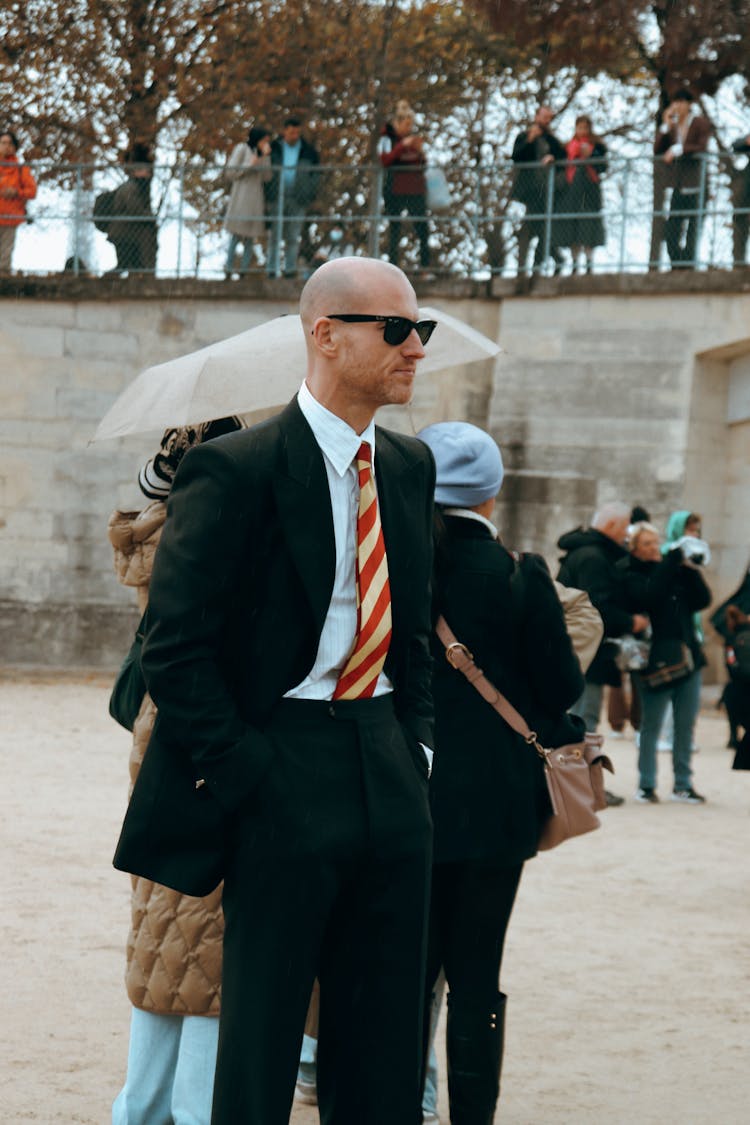 A Man In A Suit Wearing Sunglasses