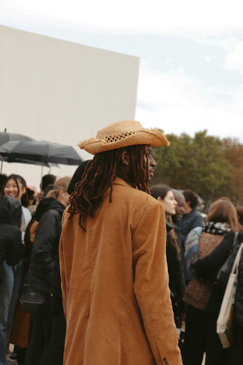 Photograph of a Man Wearing a Brown Hat