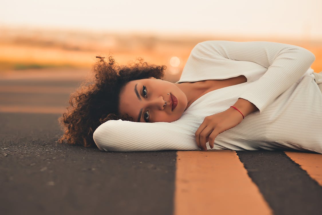 Free A Woman Lying on the Road Stock Photo