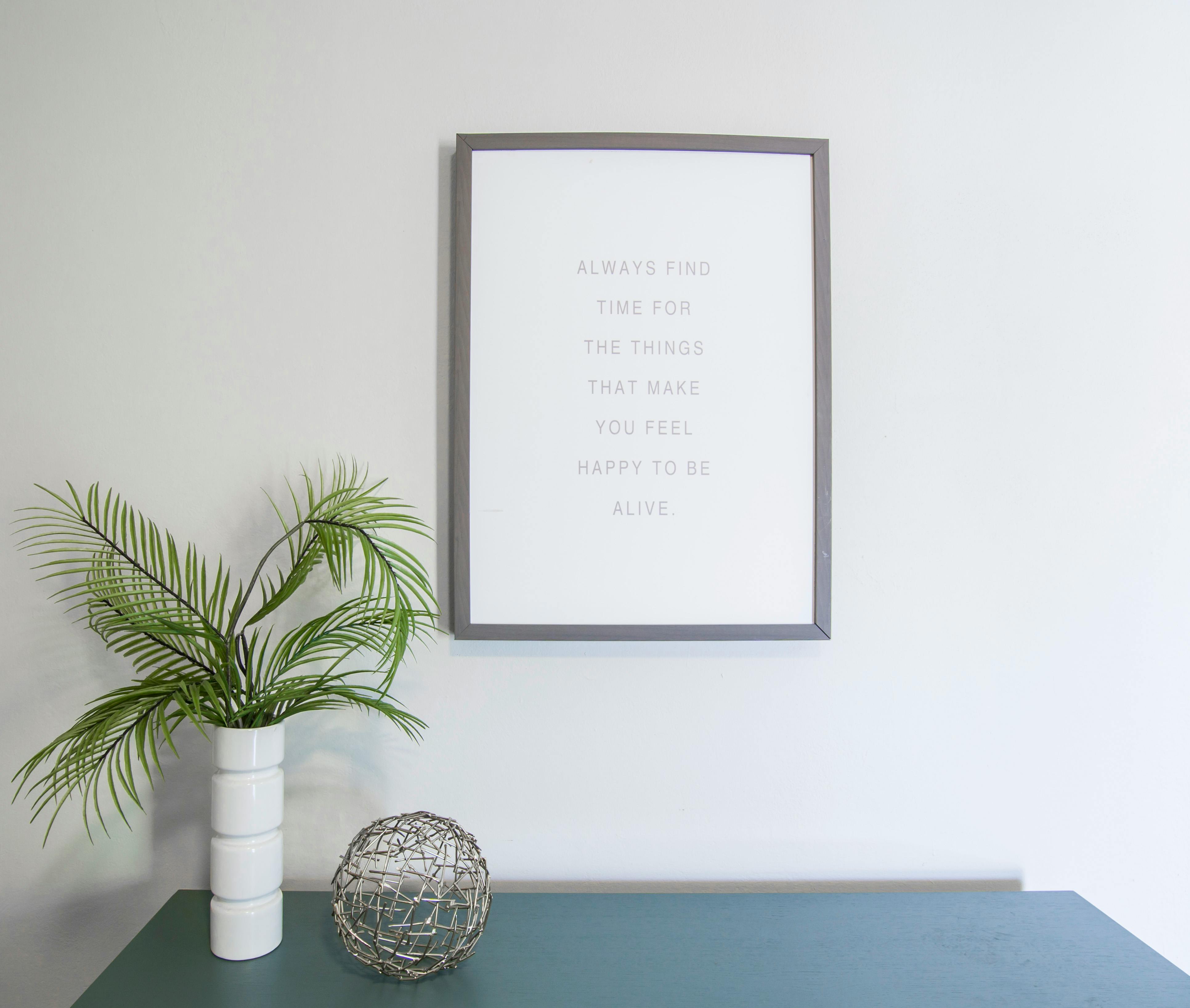 Green Leafed Plant Near Photo Frame