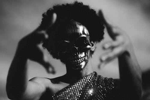 Grayscale Photo of a Person with a Skull Mask
