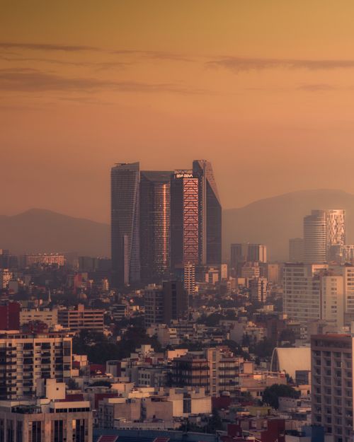 Free A stunning view of Mexico City's skyline with skyscrapers at sunset, showcasing the city's bustling architecture. Stock Photo