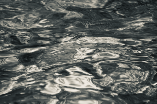 Free Black and white abstract image capturing the textured ripples on a water surface. Stock Photo