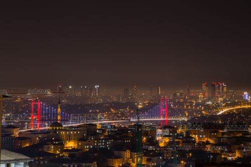 Free Stunning nighttime cityscape of İstanbul showcasing the illuminated Bosphorus Bridge and skyline. Stock Photo