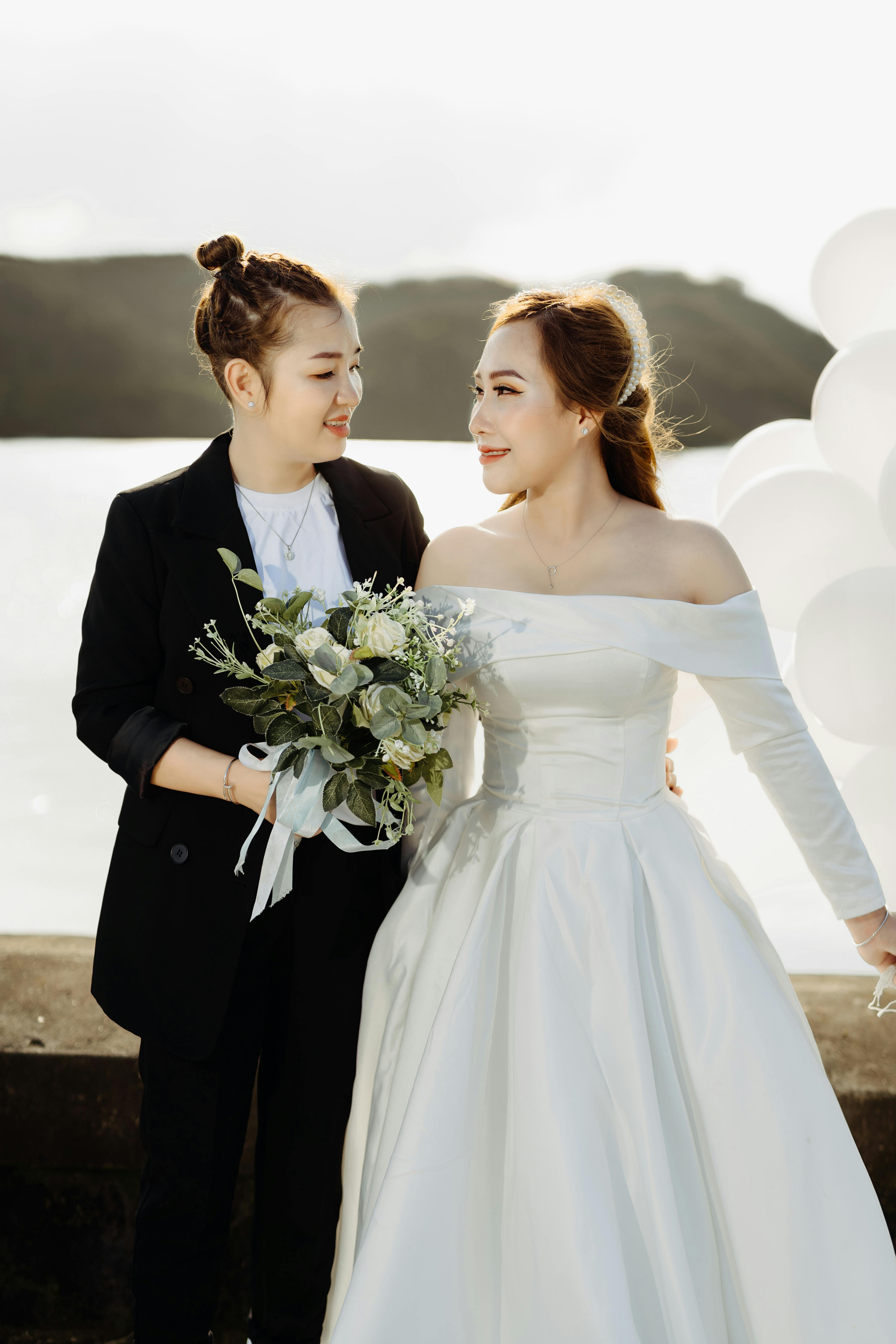 smiling women standing at the sea