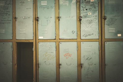 Free A row of vintage metal lockers with graffiti in an abandoned setting, offering rustic charm. Stock Photo