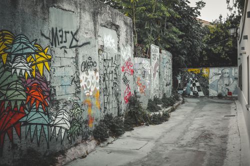 Free Vibrant graffiti art decorates an alley in Athens, Greece, showcasing urban creativity. Stock Photo