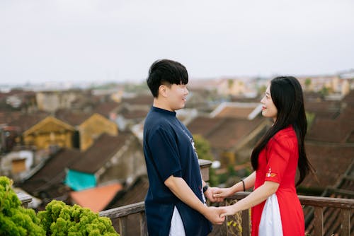 A Couple Standing Together on Top of Building