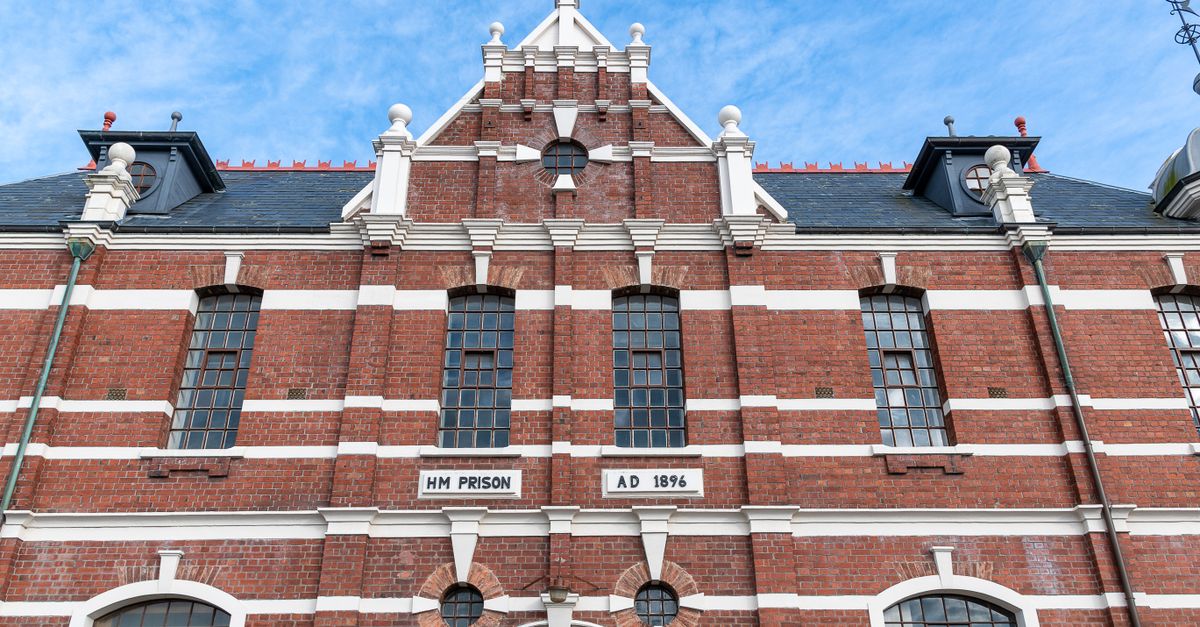 A detailed view of the historic HM Prison facade in Dunedin, showcasing its architectural brick design.
